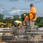 Adam Sloan, senior foreman from Track and Field Installers (TFI), and his crew work on the foundation that will ultimately contain the infield of McCurdy Track. (Photo by Jen Manell)