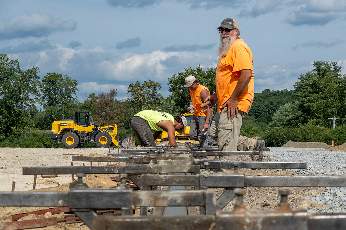 Adam Sloan, senior foreman from Track and Field Installers (TFI), and his crew work on the foundation that will ultimately contain the infield of McCurdy Track. (Photo by Jen Manell)