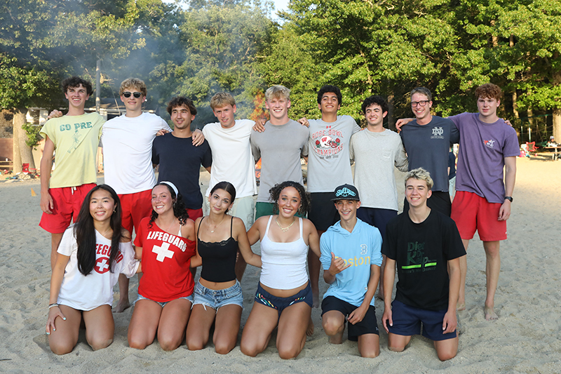 Lifeguards pose for a shot at the bonfire Thursday evening, August 6. Front row, from left: Ellie Pulido, Analucia Lora, Gigi Fenway, Ayla Dandridge, Tanner Currie, and Callan Slavin. Back row, from left: Shea Van Cleef, Jackson Whitley, Andrew Brown, Finn Piekos, Brady Quirion, Shane Trabulsi, Ethan Russo, Jack Dunn, and Theo Myles.