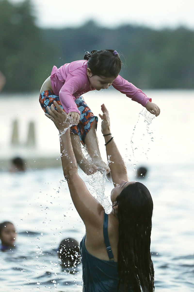 Daniela Tortora tosses daughter Iza into the air.