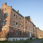 Vacant for three decades, the buildings of Vicksburg Square show signs of decay, including Revere Hall. (Photo by Lisa Aciukewicz)