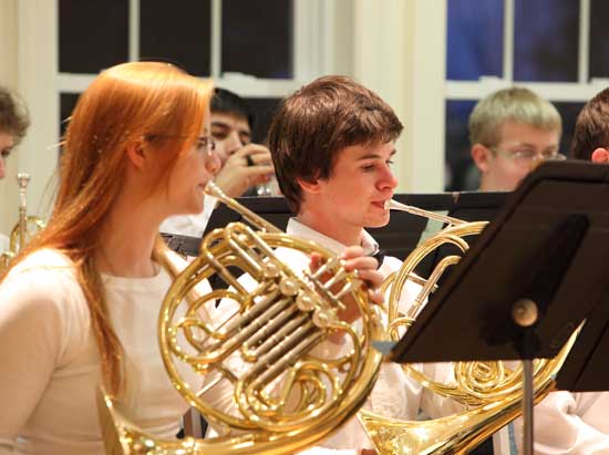 MIT Band member Fiona McCoy (left) and Bromfield junior Sam Beebe play French horn. 