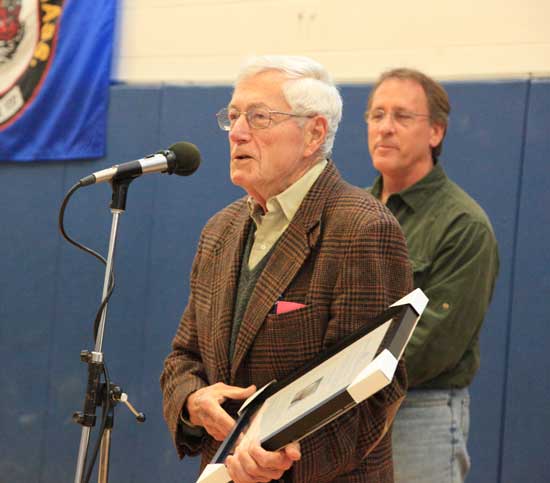 On behalf of Erhart Muller, age 103, Larry Finnegan accepts the Boston Post Cane Award that is granted to the oldest citizen in Harvard. 
